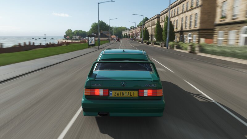 Green Car on Coastal Road — Calm