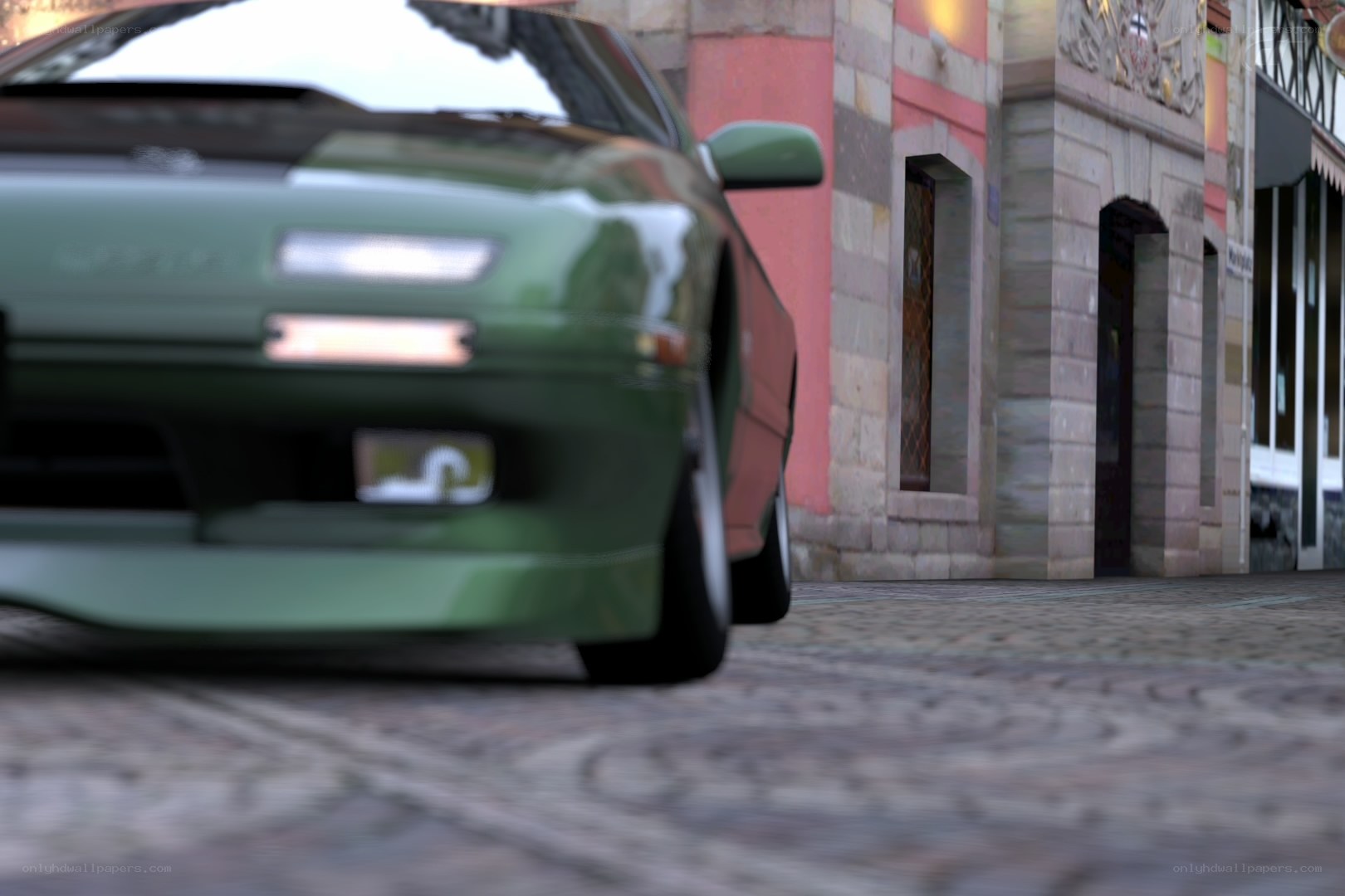 green car on cobblestone street