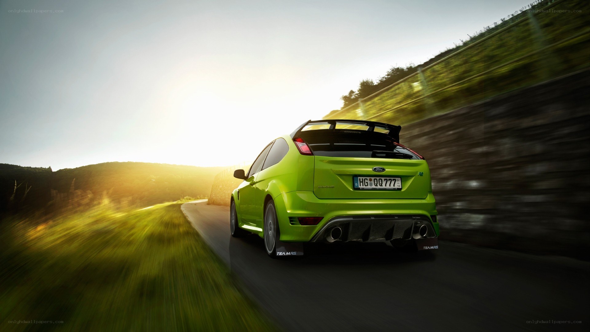 green car on country road