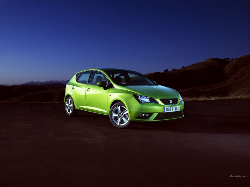 green car on dark road