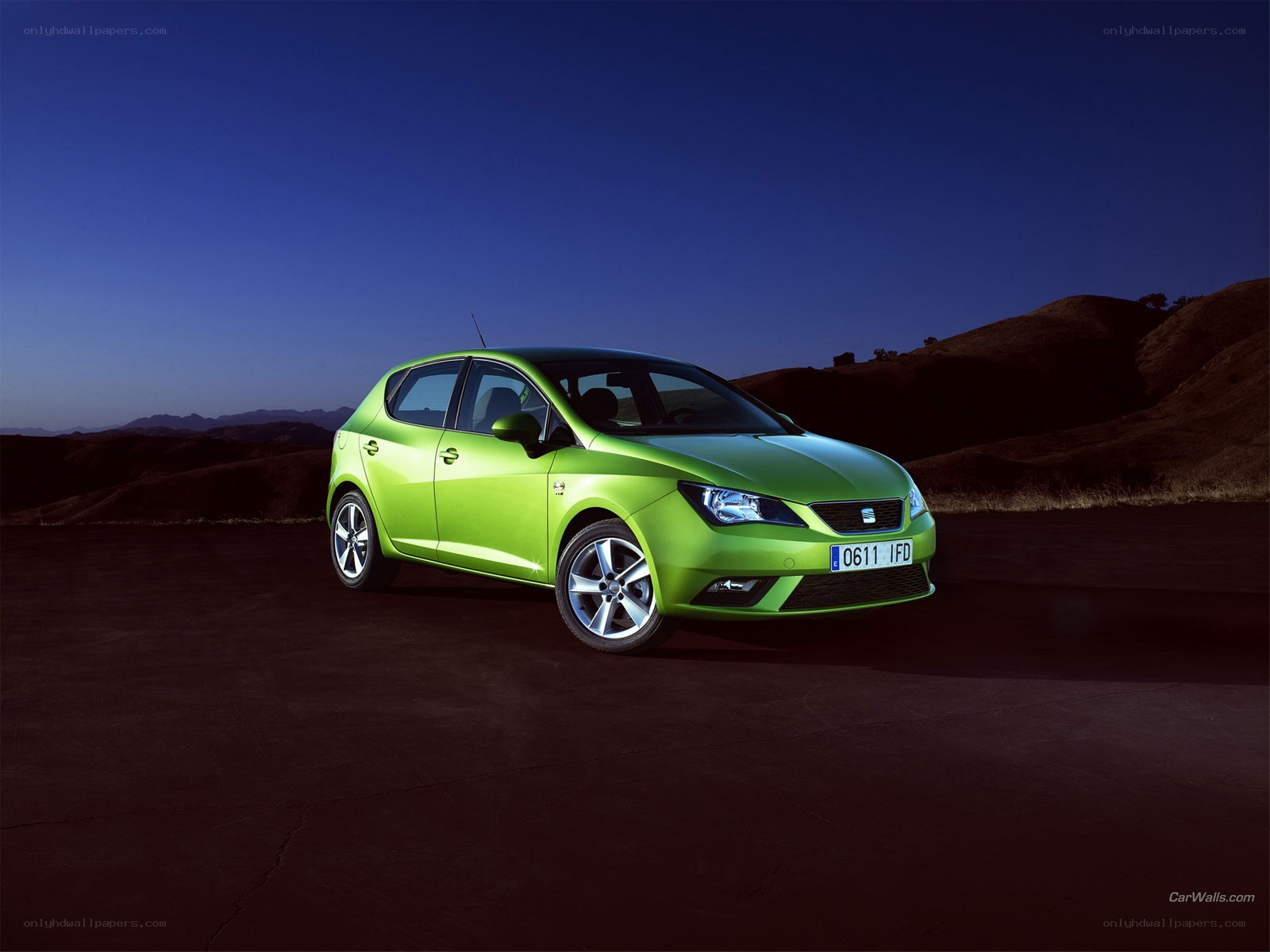 green car on dark road