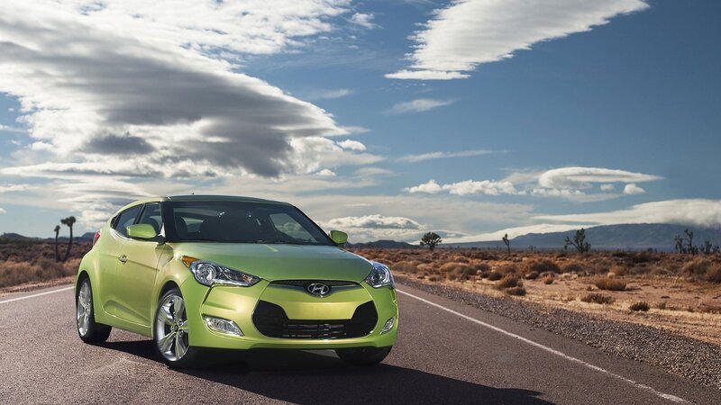 Green car on desert road