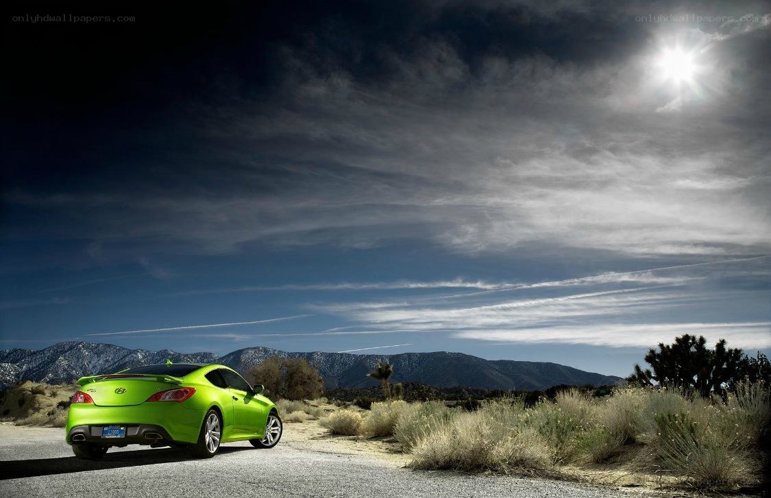 Green car on desert road
