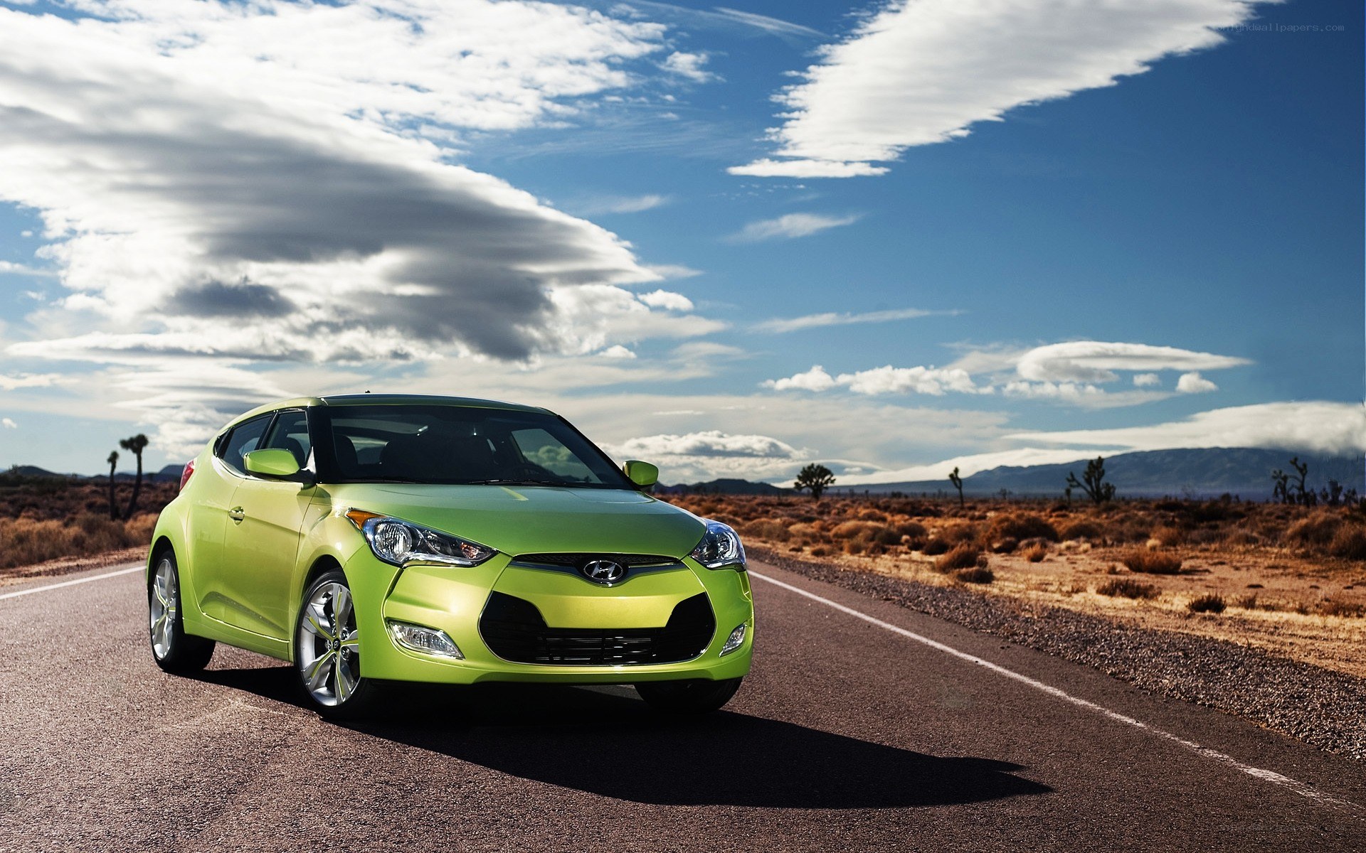 Green car on desert road