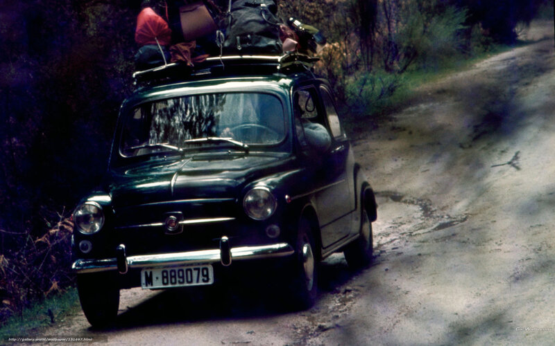 Green car on dirt road