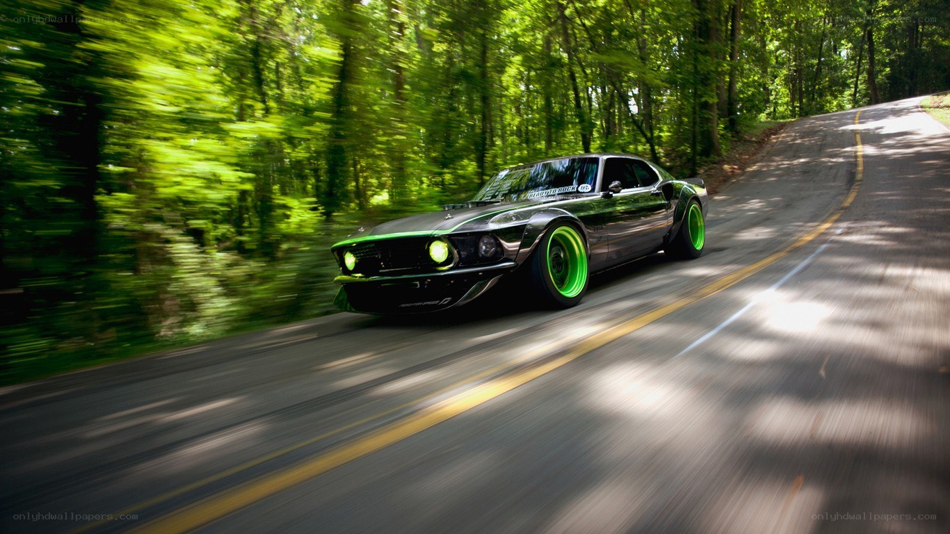green car on forest road