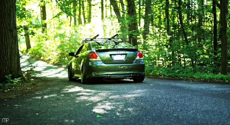 Green car on forest road