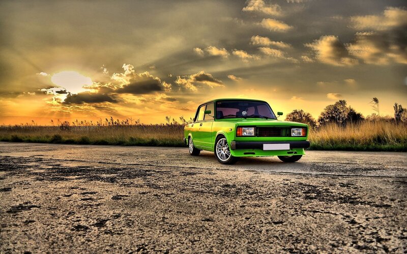 Green Car on Road — Dramatic, Sunset