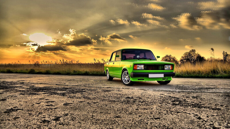 Green Car on Road — Dramatic