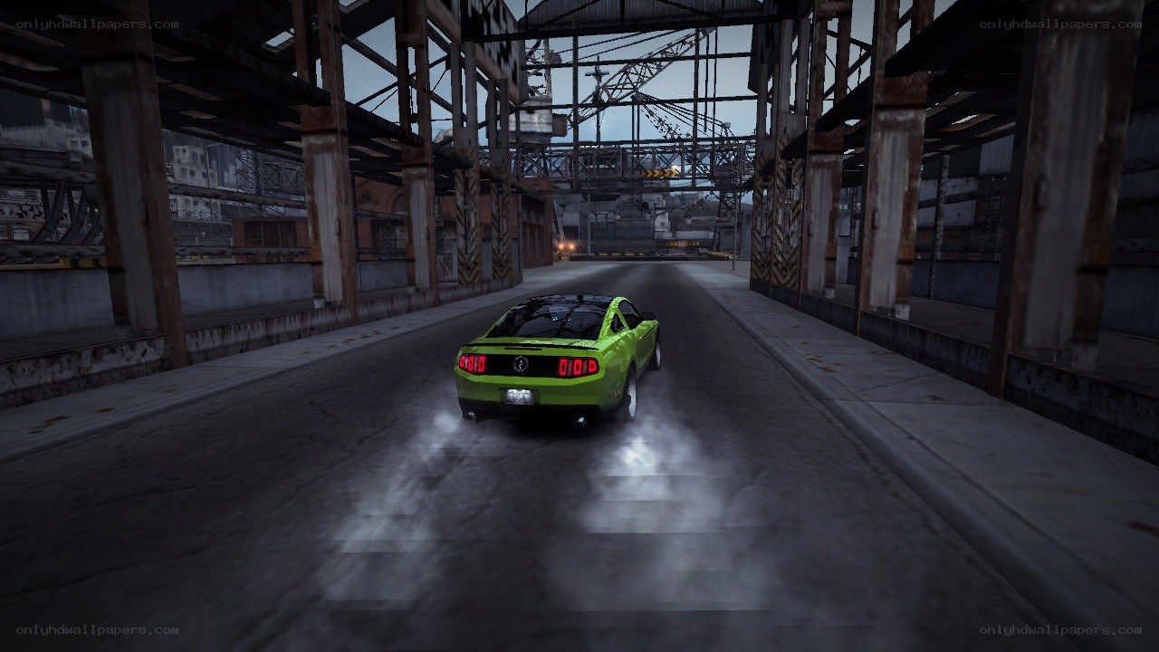 green car racing under bridge