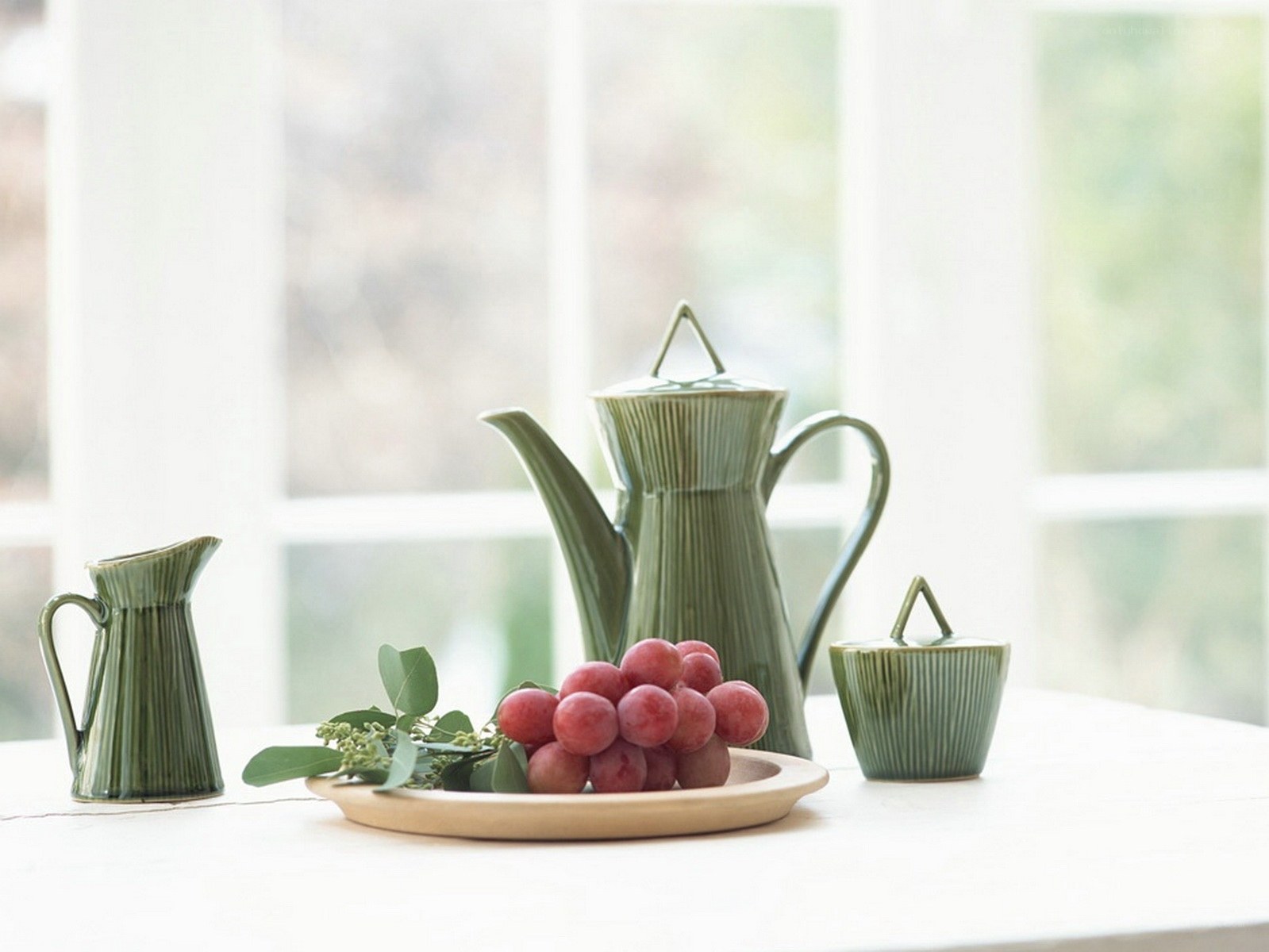 Green ceramic tea set with grapes