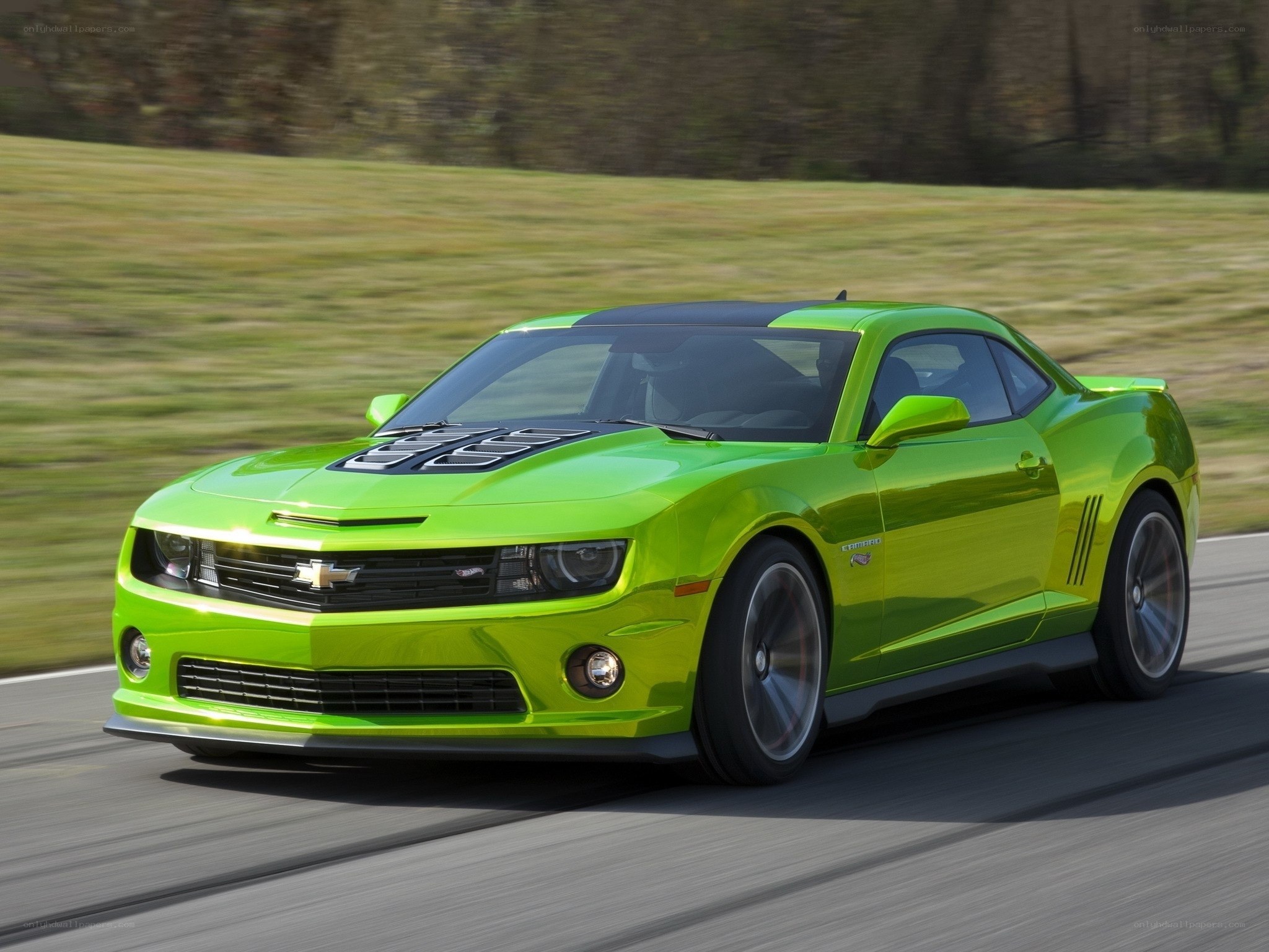 Green Chevrolet Camaro in motion