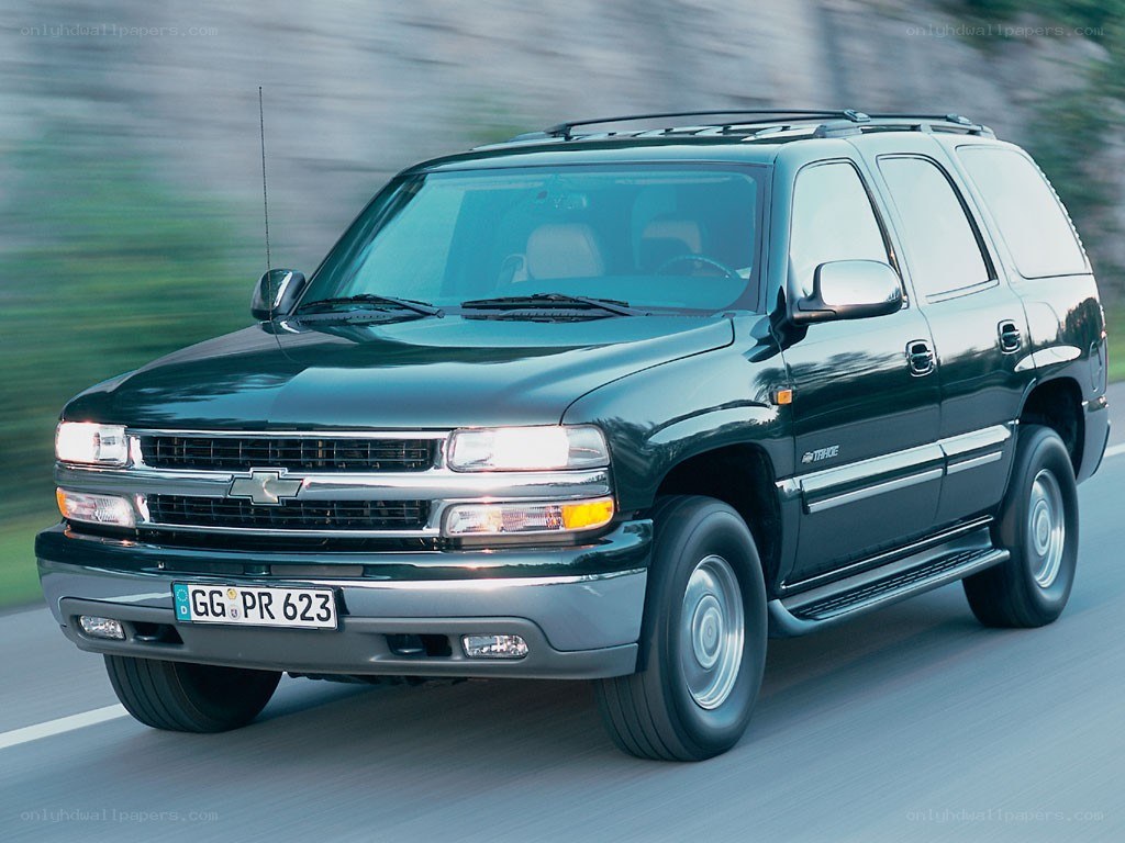 green chevrolet tahoe in motion