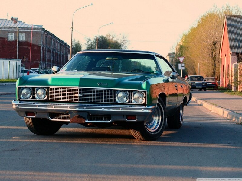 Green classic American car on street