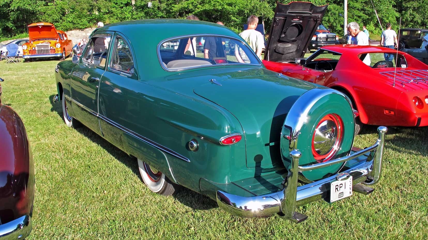 Green classic car at a show