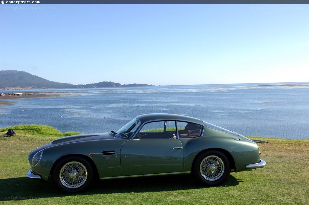 Green classic car by the sea