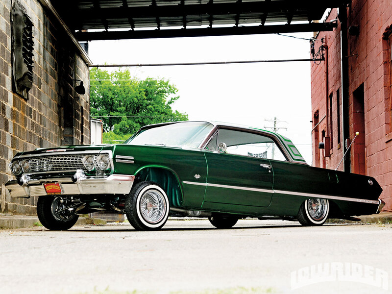 Green Classic Car — Dramatic, Afternoon, Photograph, Brick Buildings