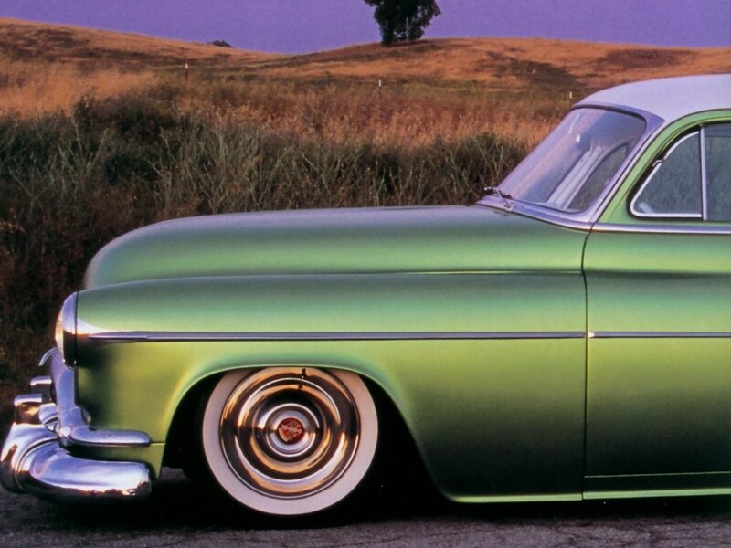 green classic car in field