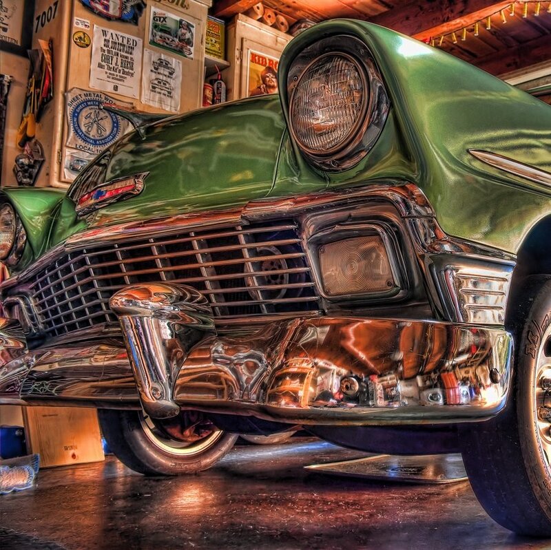 Green classic car in garage