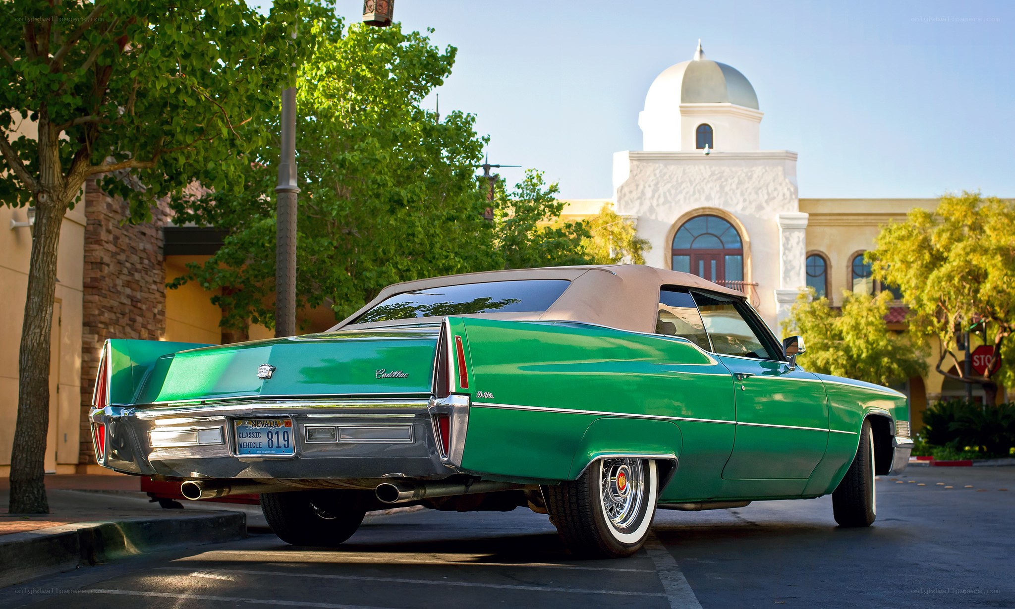 Green classic car in parking lot