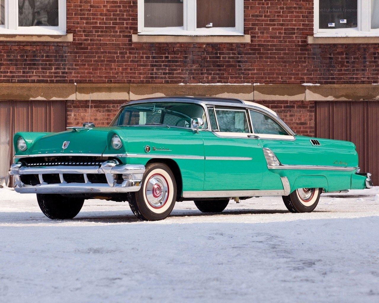 Green classic car in snow