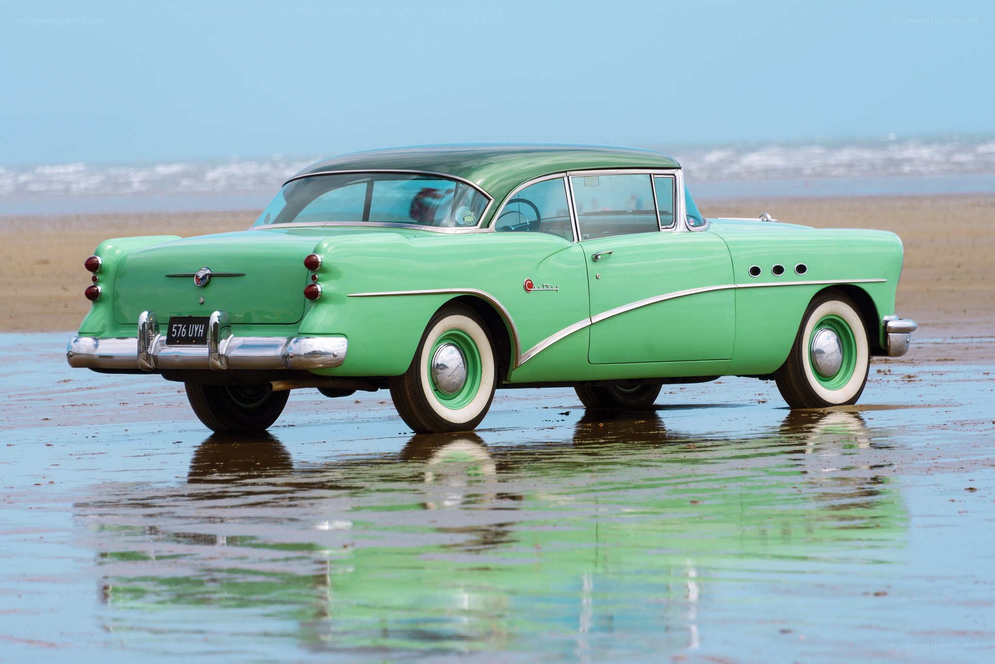 Green classic car on beach