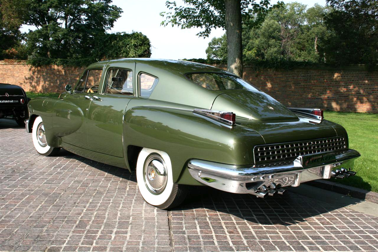 Green classic car on cobblestones
