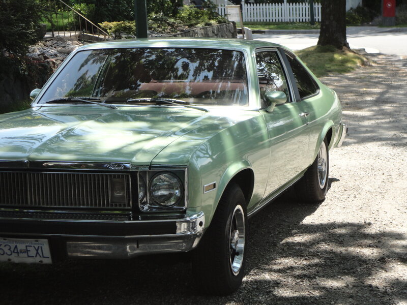 green classic car on gravel