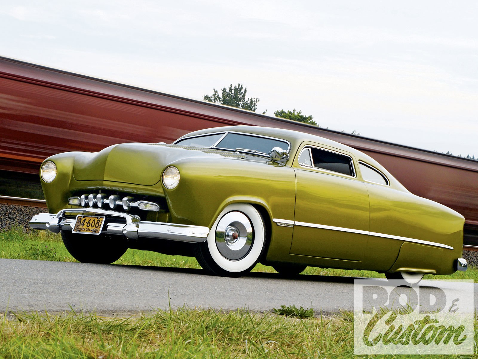 green classic car on road