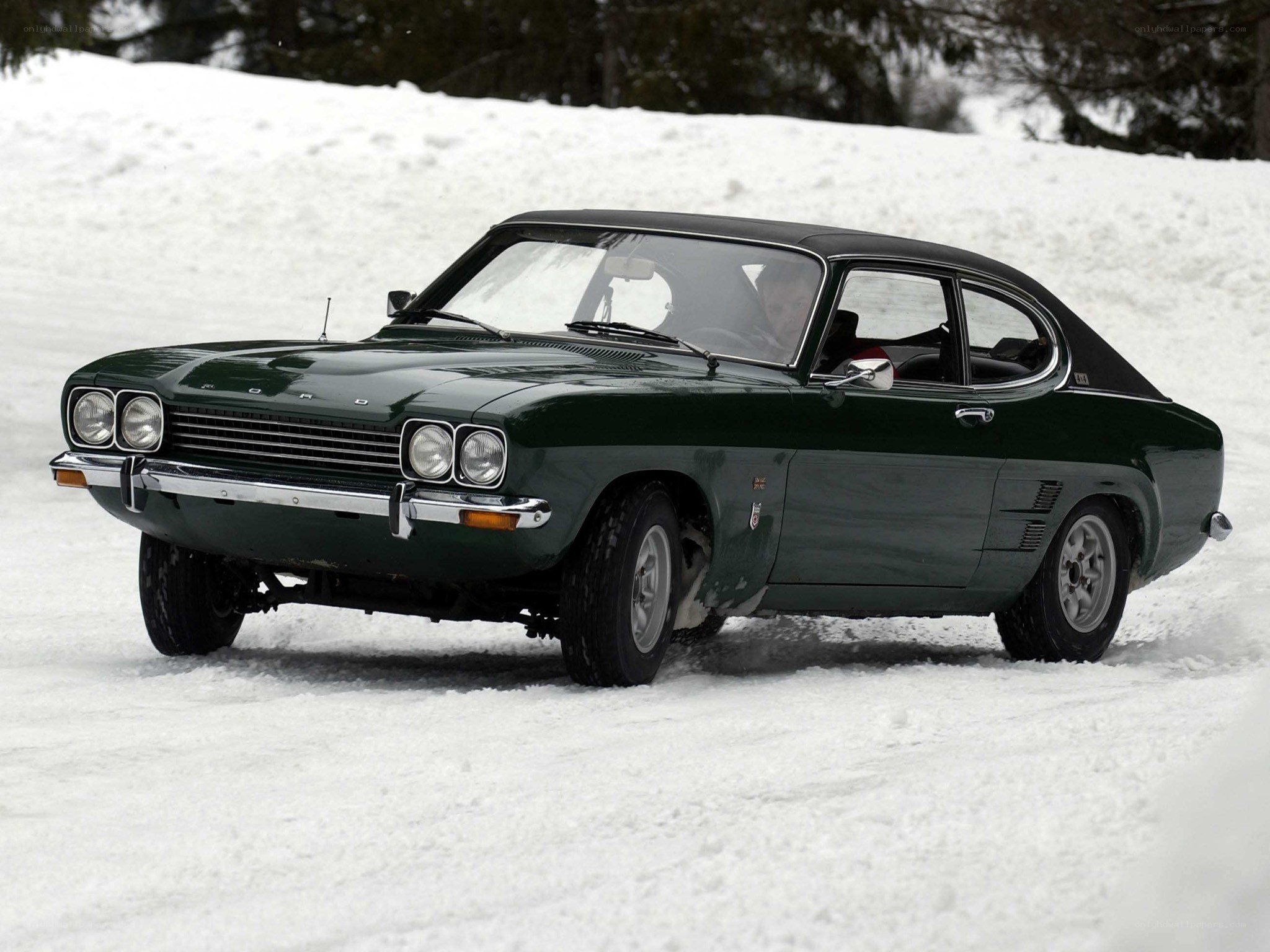 Green classic car on snow