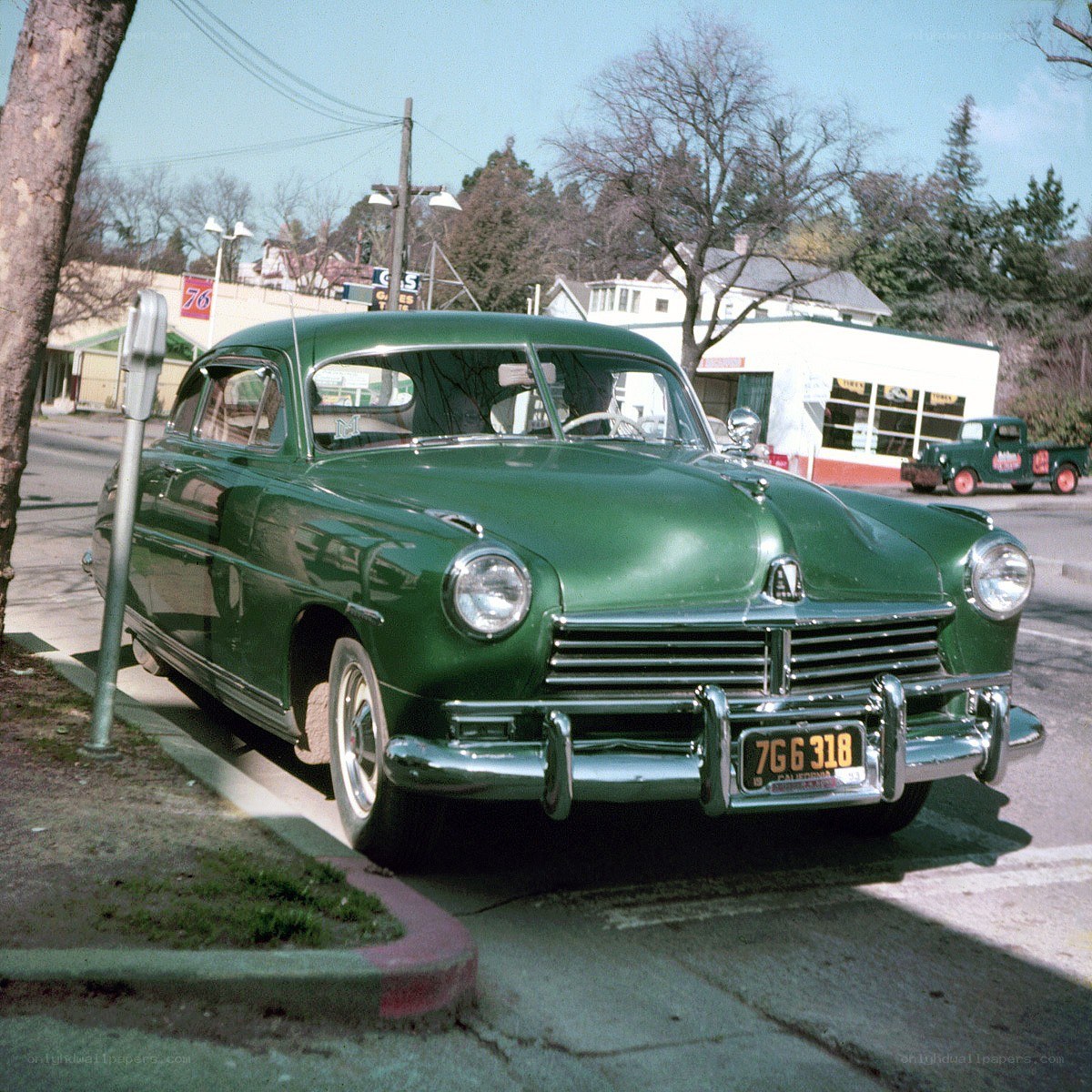 Green classic car on street