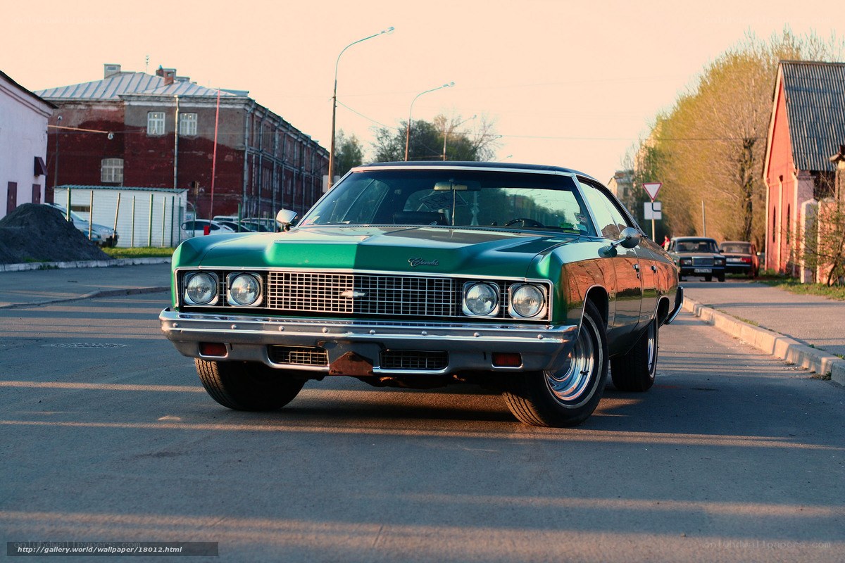 Green classic car on street