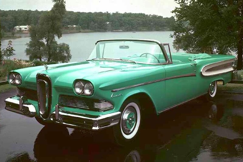 Green classic convertible by a lake