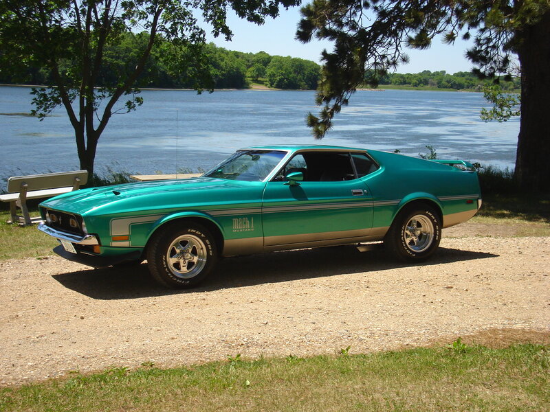 Green classic muscle car by the lake