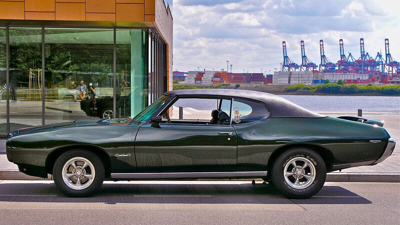 Green classic muscle car by the water