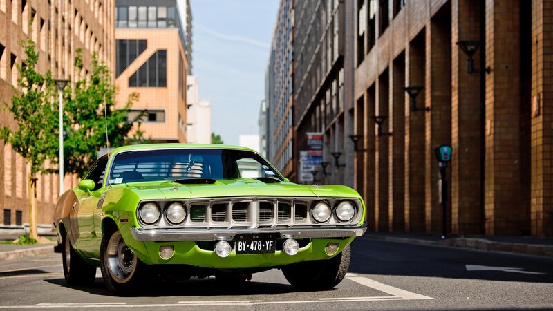 Green classic muscle car in city