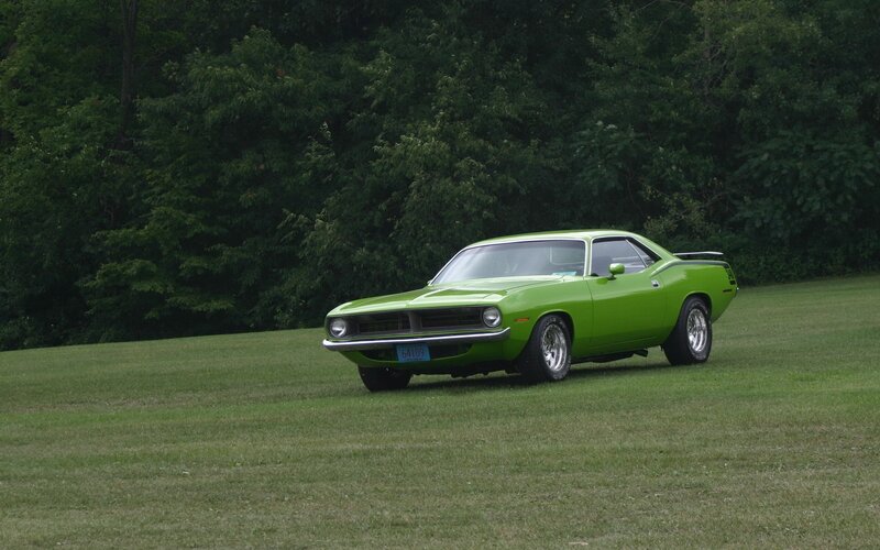 Green classic muscle car on grass