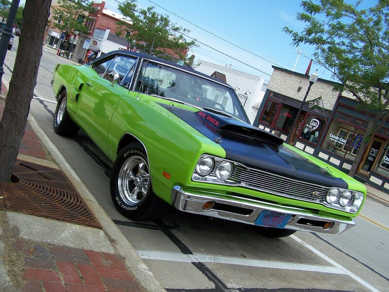 Green classic muscle car on street
