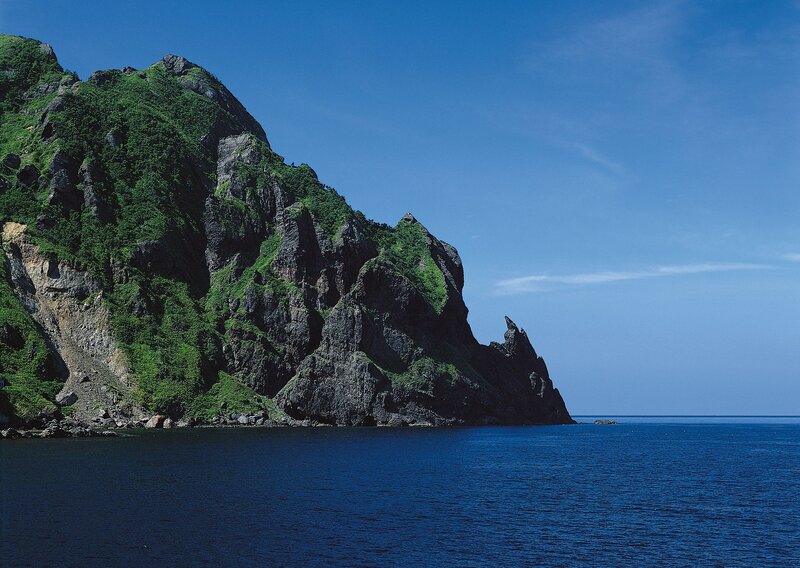 Green Cliff by Ocean — Blue