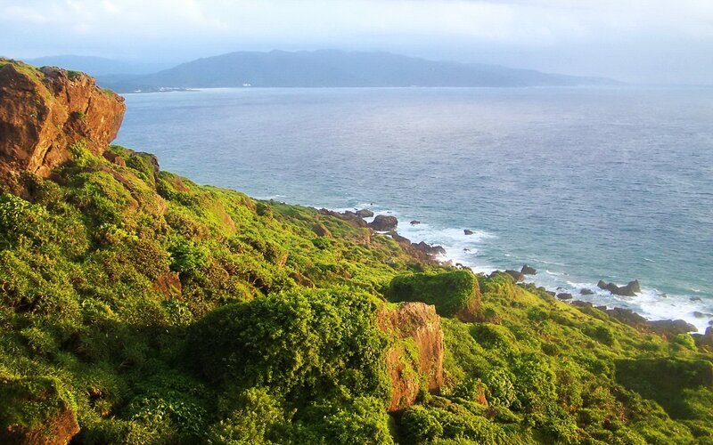 Green Cliff Overlooking Ocean — Serene