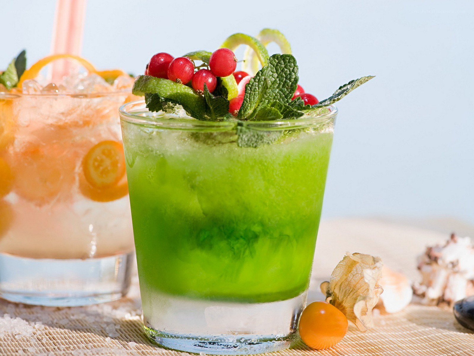 Green cocktail with berries and mint
