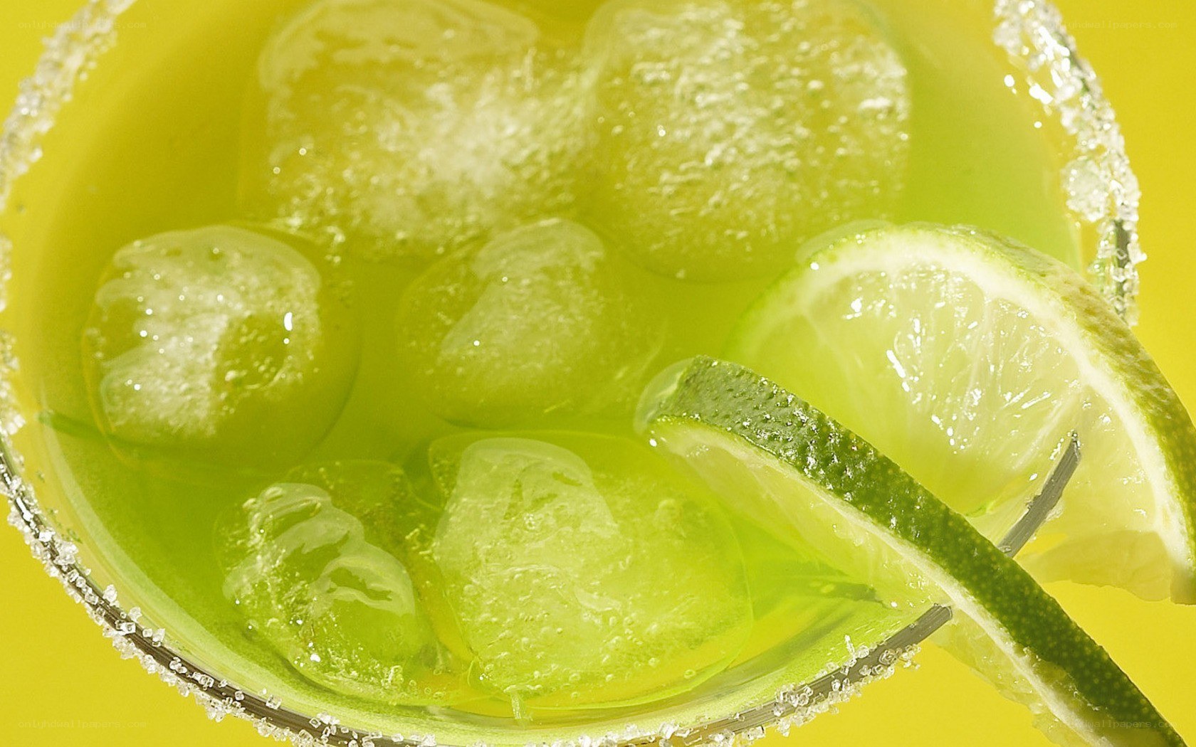 green cocktail with lime and ice