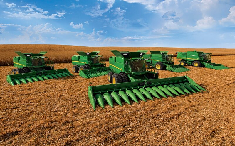Green combines in a field