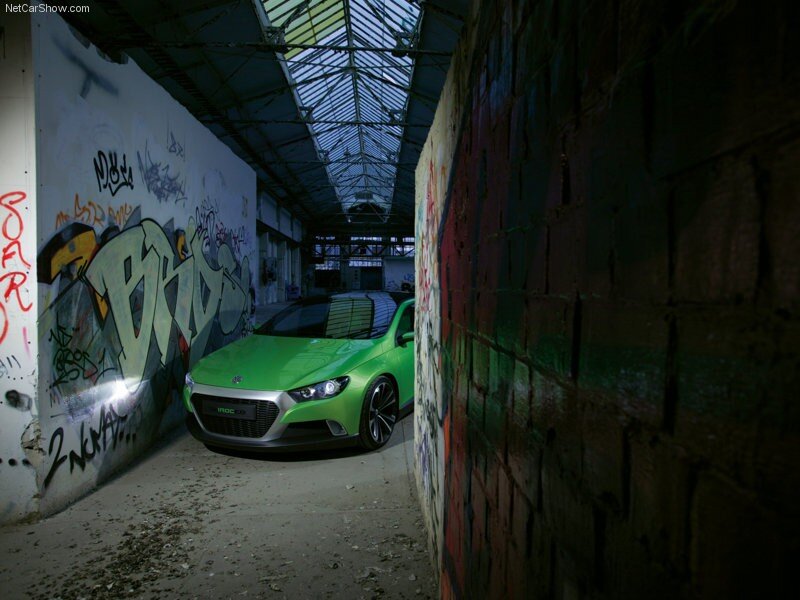 Green concept car in graffiti alley