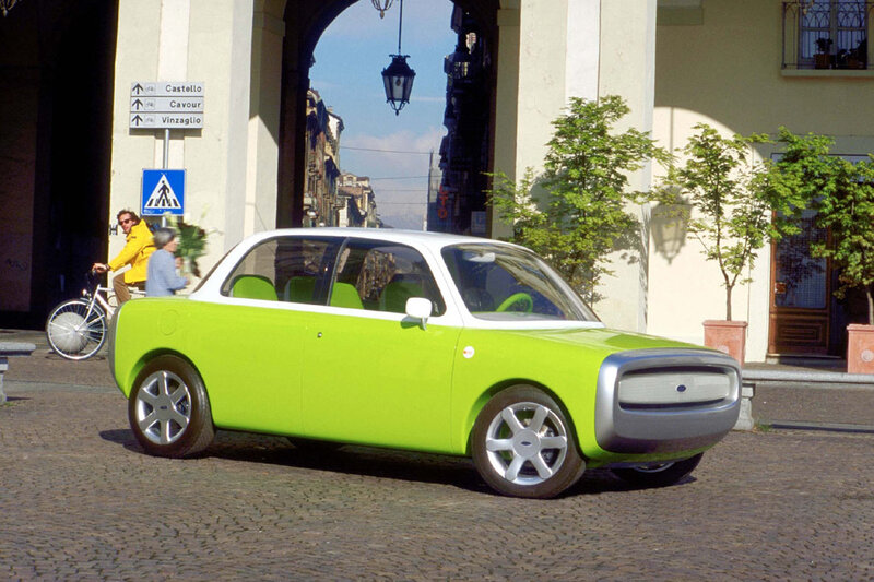 Green concept car on cobblestones