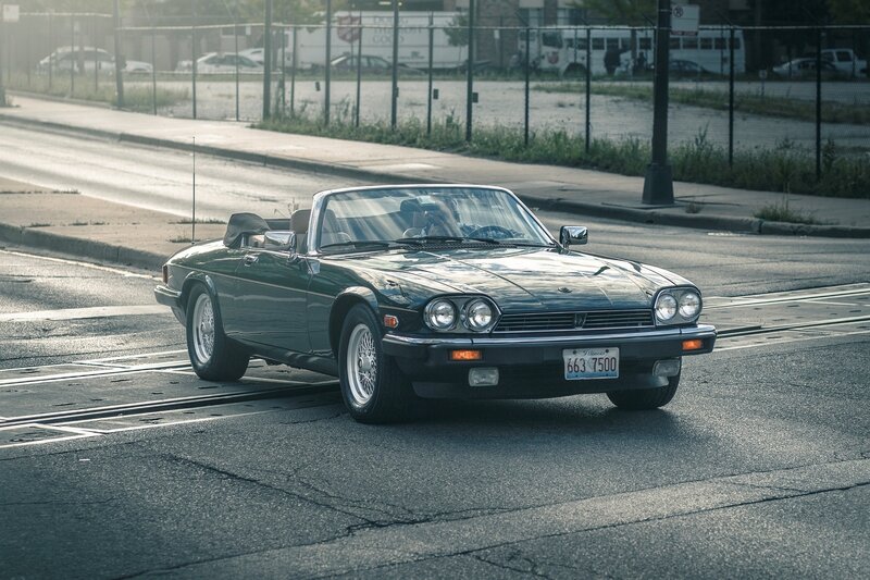 Green convertible on city street