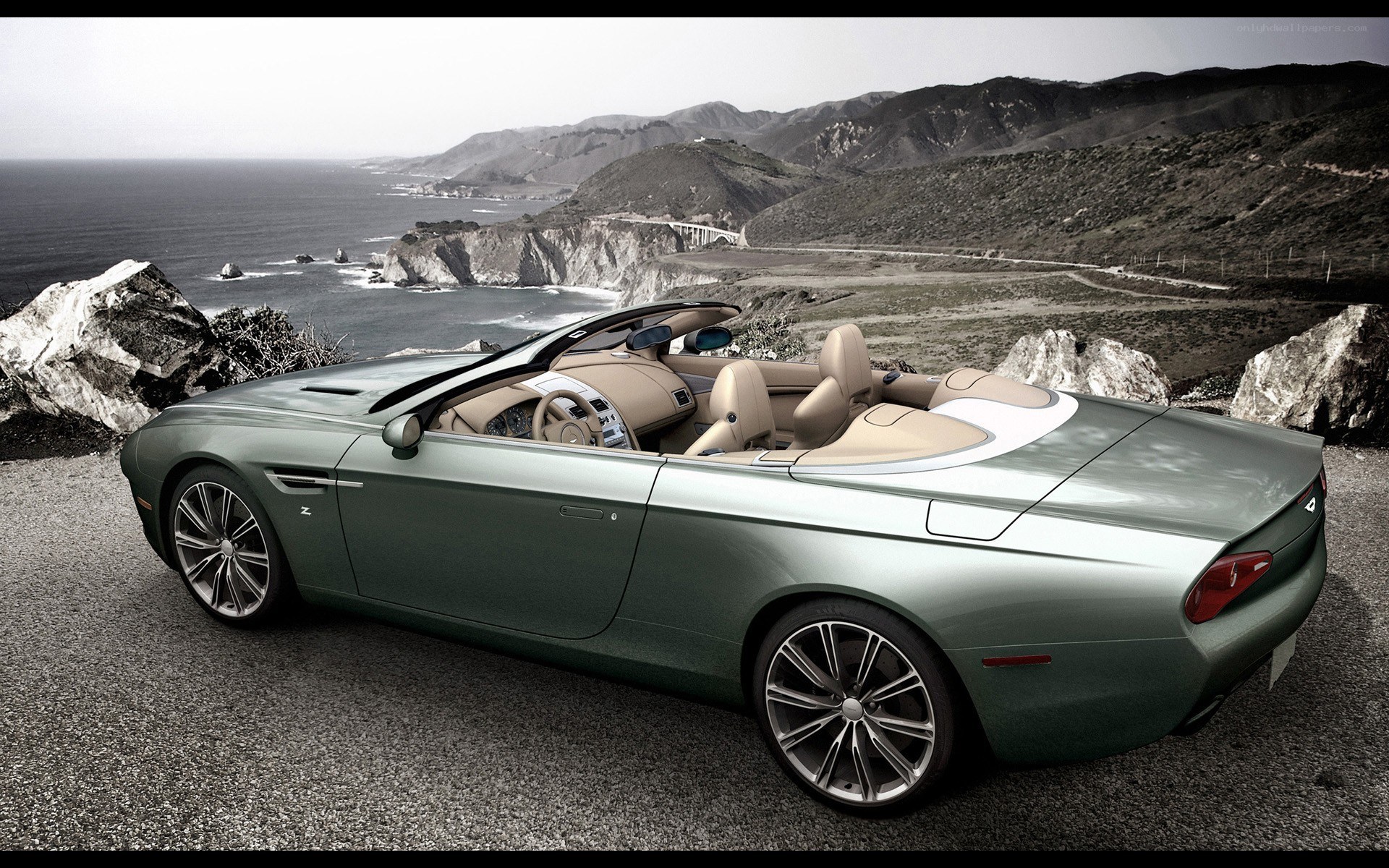 Green convertible on coastal road