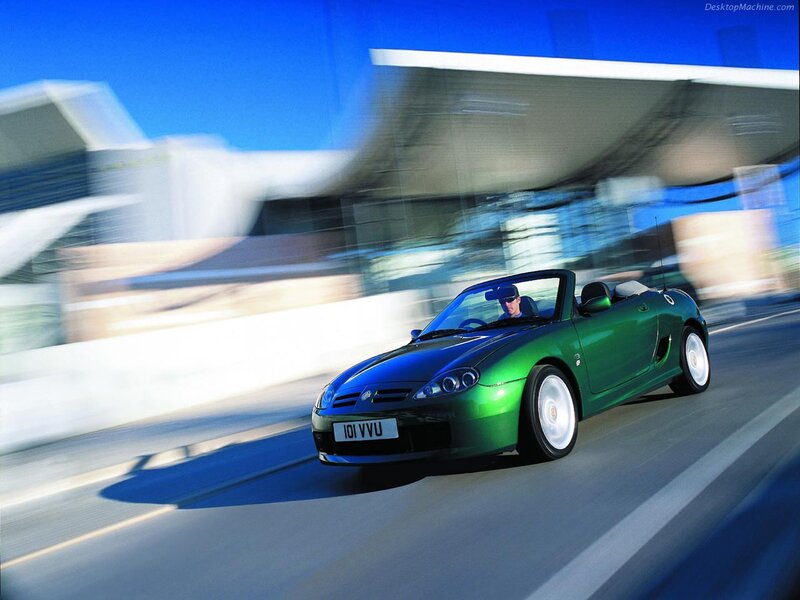 Green convertible sports car in motion