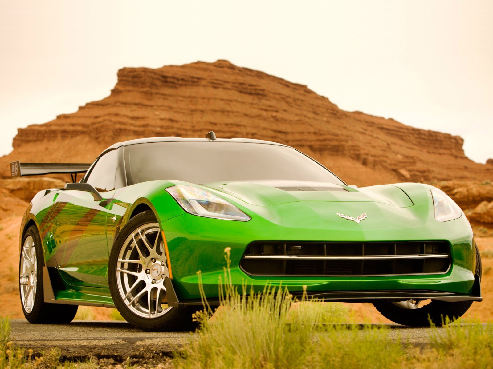 Green Corvette in desert landscape