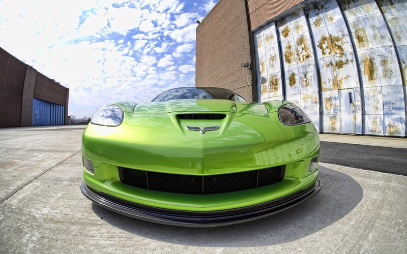 green corvette in industrial lot